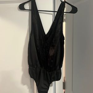 Black silky bodysuit. Size small. Brand: pretty little thing.